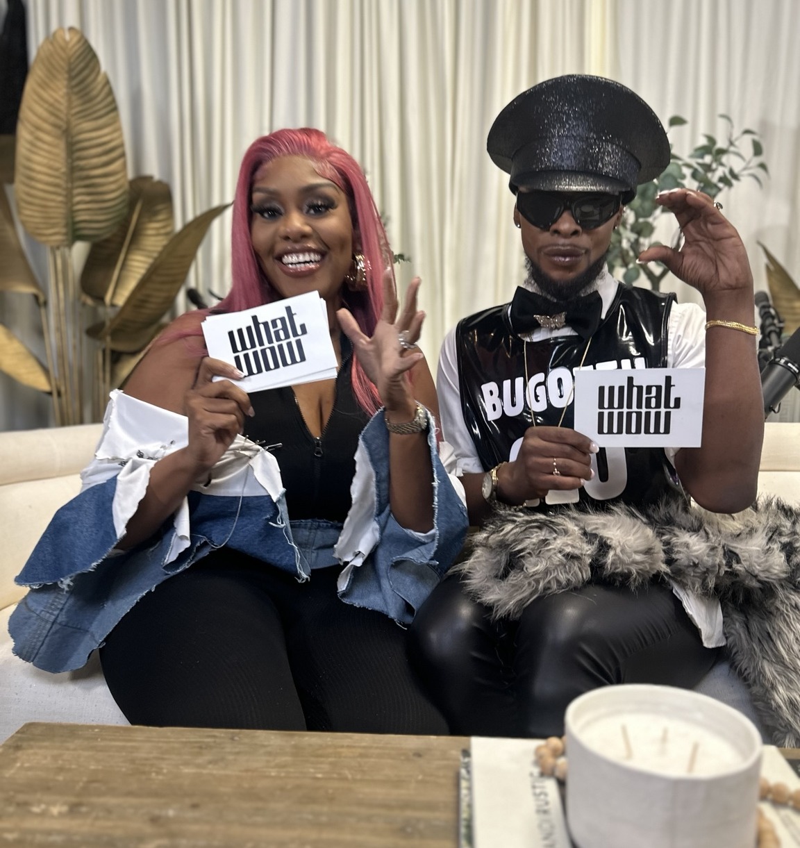 Nikki and a guest holding their WhatWow cards on set